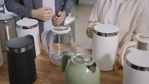 A Man and a Woman in an Electronics Store Choose an Electric Kettle with Wifi and Automatic