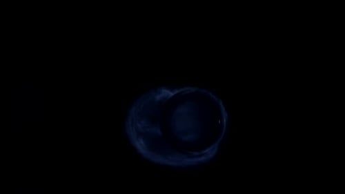 Blue Smoke Swirls Around Dark Rotating Orb