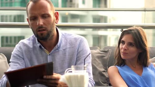 Young, Happy Couple Placing Order to Waiter in Bar on Terrace Adult