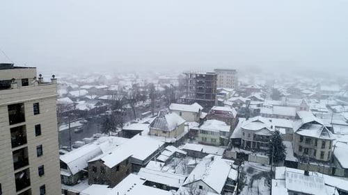 Aerial view a city during heavy snowing