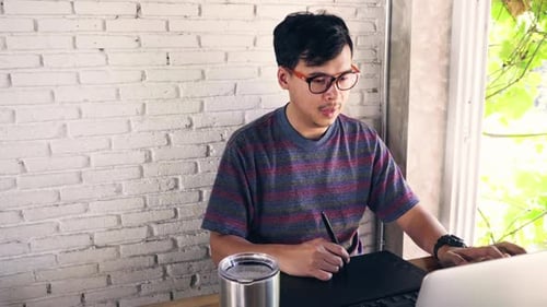 Man Working with Graphics Tablet at Modern Office