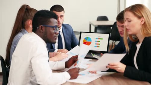 International Business Partners Discuss Financial Project Results on Meeting in Office Multiethnic