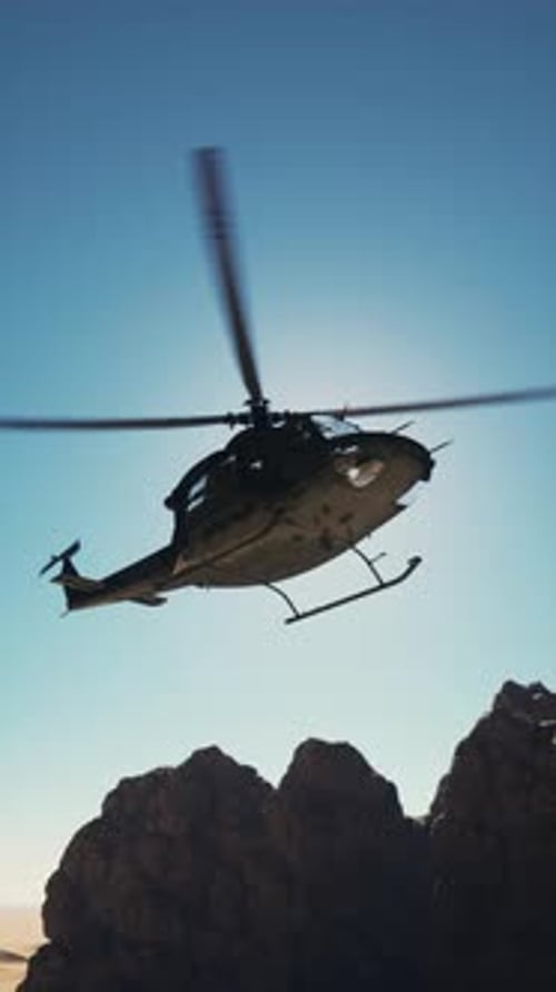 Retro American Military Helicopter Flying Over Mountain Range