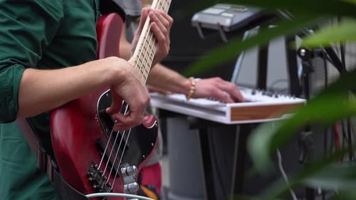 Guitarist playing a guitar riff on an electric guitar at a street music festival. Cover band