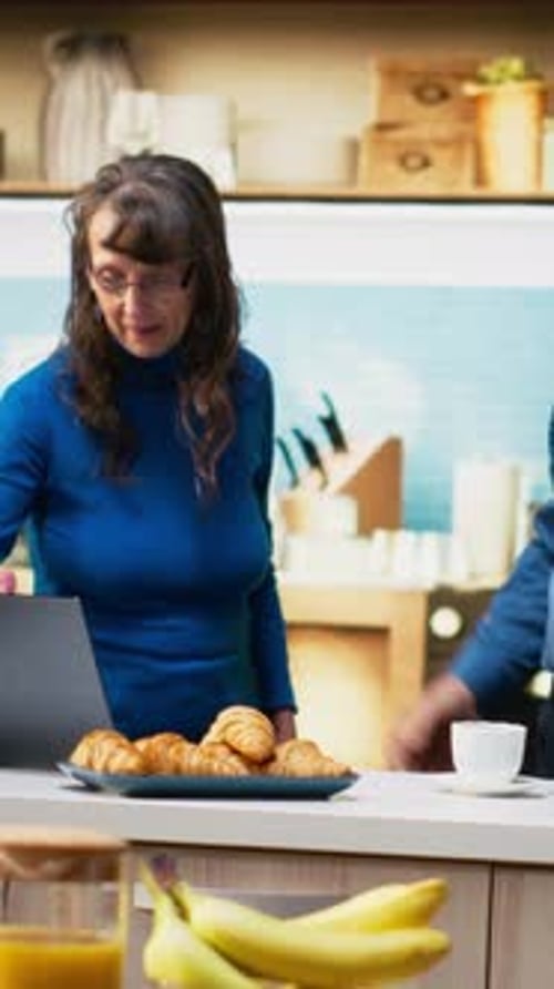 Mature Couple Dancing Together in Kitchen at Home