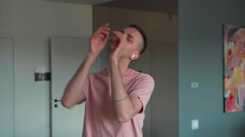 Man Listening to Music and Dancing Indoors