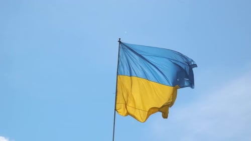 Ukrainian Flag Waving Against Blue Sky