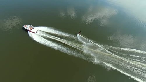 Man wake surf boarding on river. Extreme summery water sport aerial view.