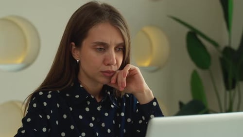 An Overworked Business Woman Working in a Modern Office an Office Worker with a Laptop Experiencing