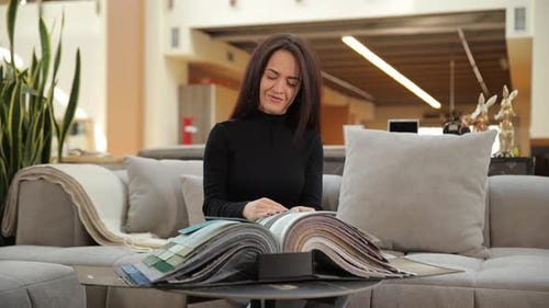 Woman Choosing Fabric Samples for Interior Design Project