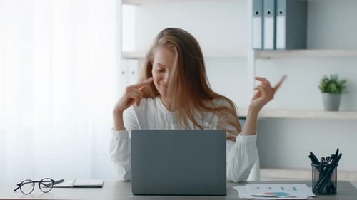 Young Businesswoman Enjoying a Moment of Joy in a Modern Office Setting