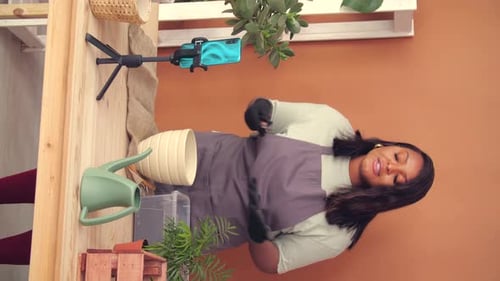 Woman Gardening While Filming Herself on Phone
