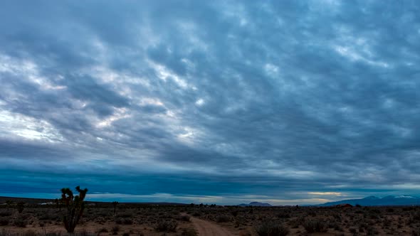 Sunset cloudscape over the Mojave Desert's arid and rugged landscape on ...