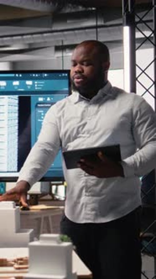 Vertical Video Property Investment Developer Checks Blueprints and Layout Plans