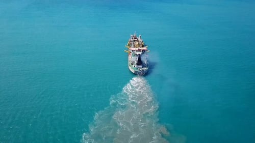 Trailing Suction Hopper-Dredger ship roaring across the sea