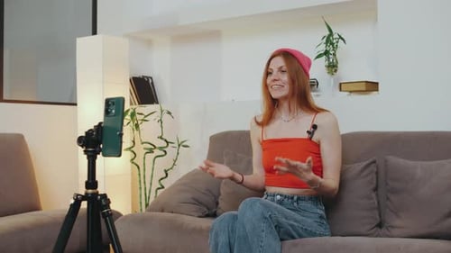 Woman Vlogging on Smartphone in Bright Modern Living Room