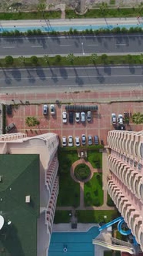 Vertical Video Aerial View of Busy City Traffic with Cars Moving Along Roads and Intersections in