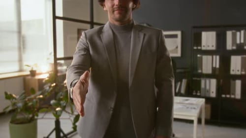 Midsection of Male Entrepreneur Extending Hand in Greeting in Modern Office