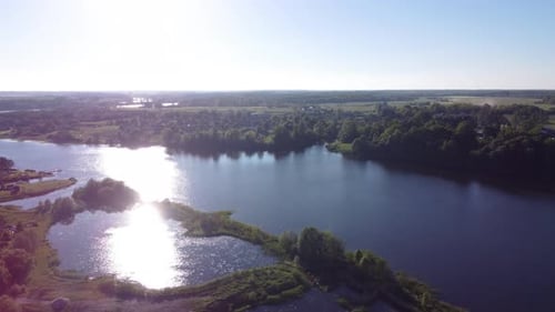 AERIAL Orbiting Shot of a Wide River in Lithuania