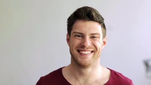 Smiling young man looking directly at camera