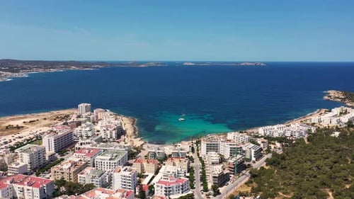 Aerial drone footage of the town of Sant Antoni de Portmany on the west coast of Ibiza in Spain
