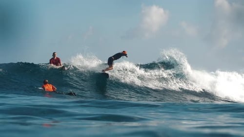 Male Surfer Rides the Wave in Water View of the Rider Surfing the Wave
