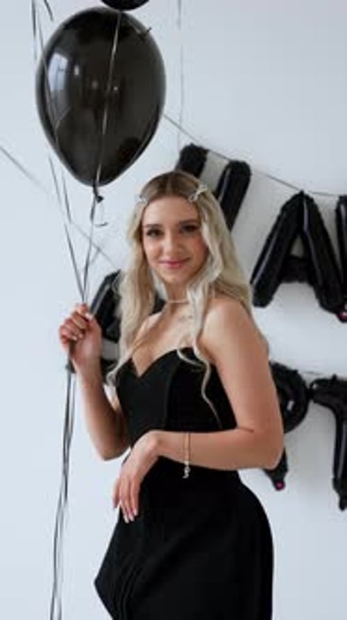 Blonde Woman Holding Balloons at Birthday Celebration