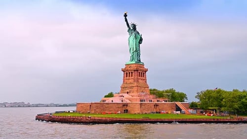 Statue of Liberty from low angle perspective. Some building materials at the foot of the monument.