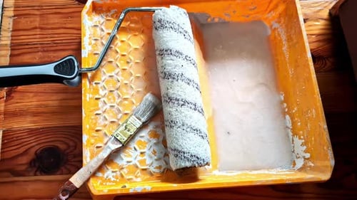Paint Tray with Roller and Brush on Wood