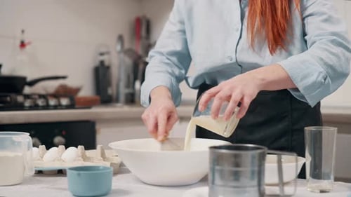 Woman Mixing Ingredients in Bowl to Bake in Kitchen