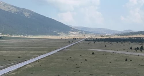 Aerial View of Road in Beautiful Green Fields at Beautiful Sunny Day in Summer