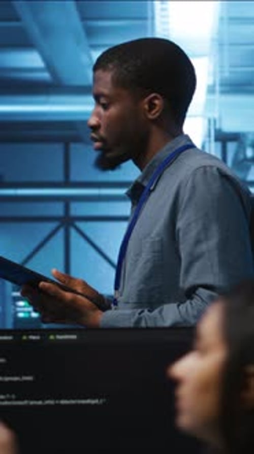 Man Working on Tablet in Server Room