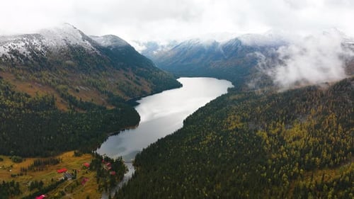 Aerial view of Rakhmanovskoe Lake amidst autumn mountains