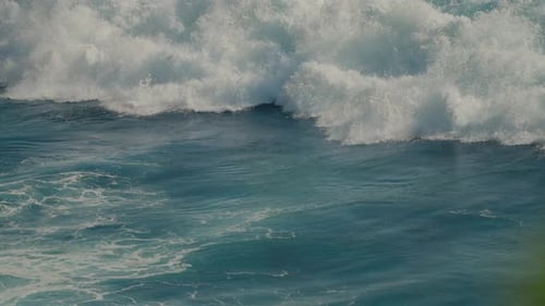 Foamy white water wave crashing in super slow motion. Power of the ocean.