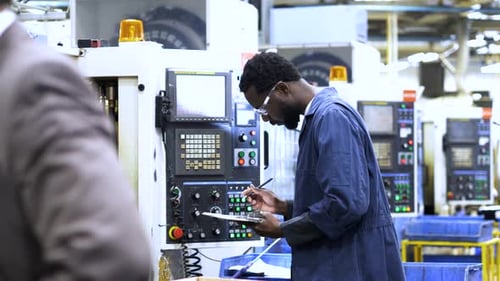 Factory Worker Inspecting Control Panel