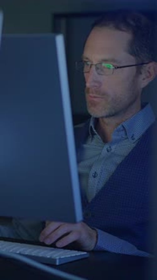 Man Working at Computer in Dark Office