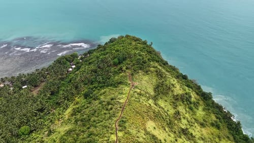 The view of lush green mountains meeting the turquoise ocean