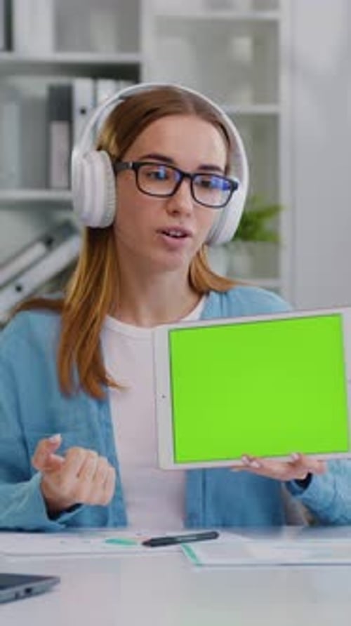 Young Pretty Woman Sit at Desk Makes Videocall Conference Speech and Showing Green Screen Digital