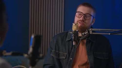 Young Male Podcast Member Speaking in Mic in Recording Studio