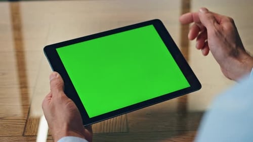 Man Hand Touching Green Tablet Screen Indoor Closeup. Unknown Businessman Using Chroma