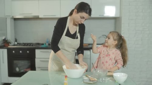 Mother and Daughter Baking Together in Bright Kitchen