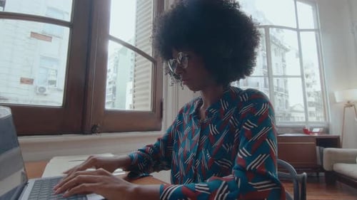 Young African-American Businesswoman Working on Laptop in the Office