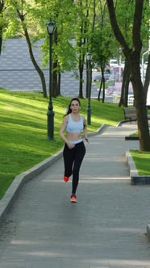 Vertical Screen Female Jogger Training in Green Park
