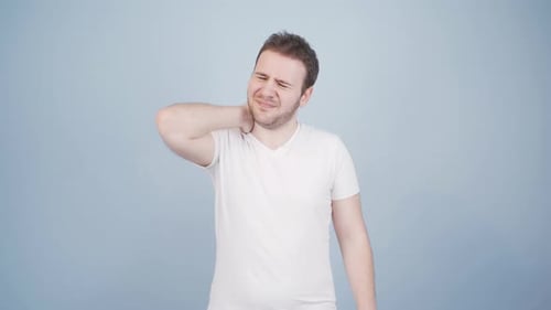 Man Rubbing Neck Experiencing Neck Pain