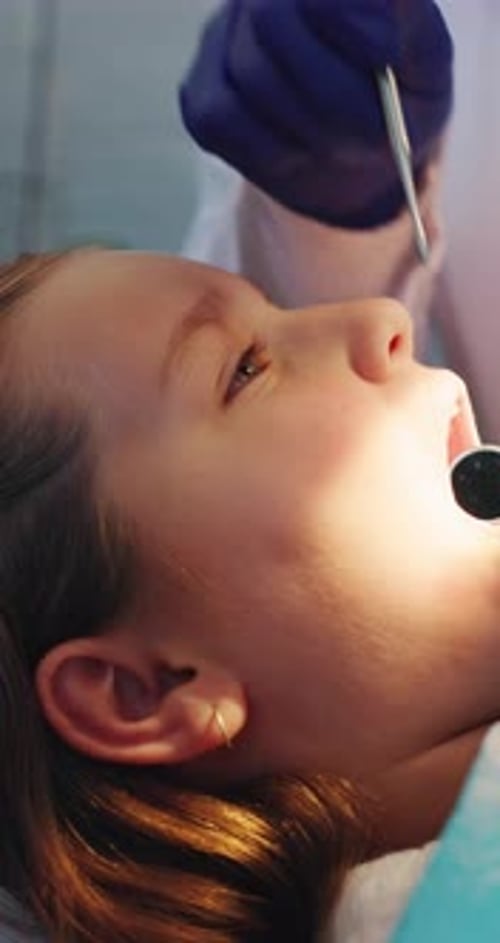Child, dentist or hands with mirror for teeth cleaning, extraction or tooth filling in clinic