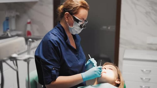 Dental Treatment in Medical Clinic Female Stomatologist in Surgical Mask Dentistry and Dental Care