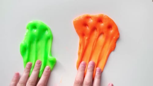 Playing with Textured Slime with Bubbles Stretching the Gooey Substance Female Teen Hand Holding