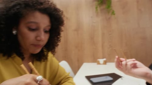 Employees Communicating while Eating during Lunch Break in Office Cafeteria