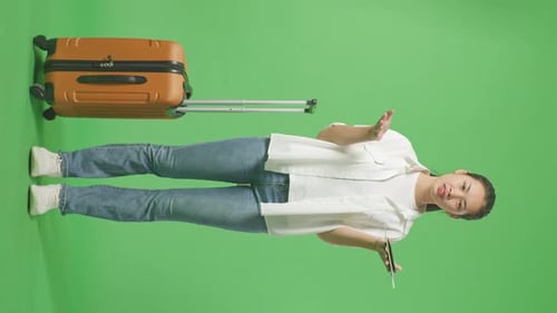 Full Body Of Wondering Asian Female Traveler With Luggage And Doubtfully In The Green Screen