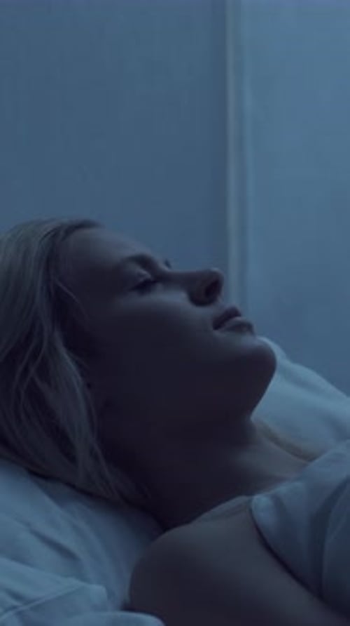 Woman Sleeping Peacefully in Bed at Night